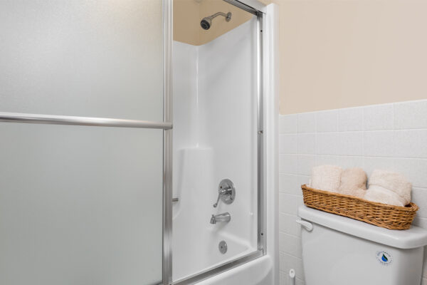 A shower and toilet at Chesterfield Village Apartments