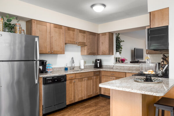 A marble kitchen countertop with views into other rooms at Chesterfield Village Apartments