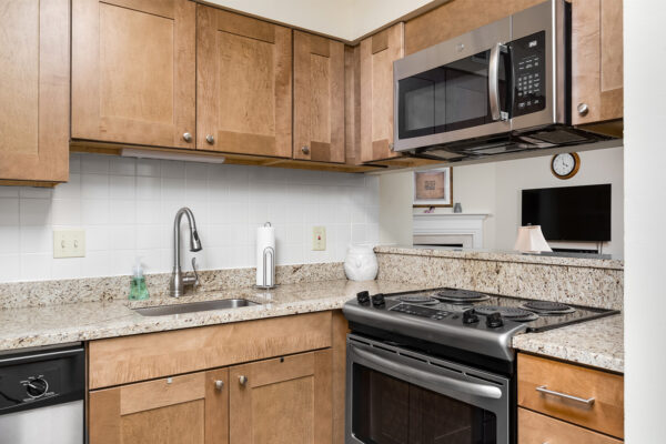 A marble kitchen countertop with stainless steel appliances at Chesterfield Village Apartments