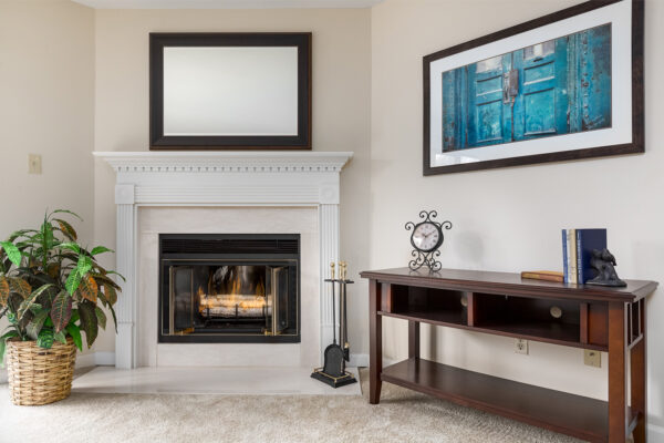 A living room fireplace and mantle at Chesterfield Village Apartments
