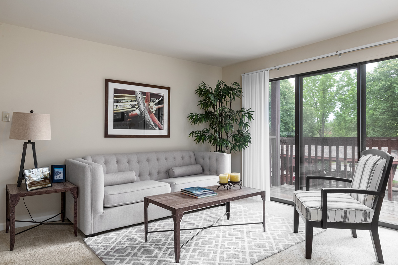 A living room with a deck at Chesterfield Village Apartments