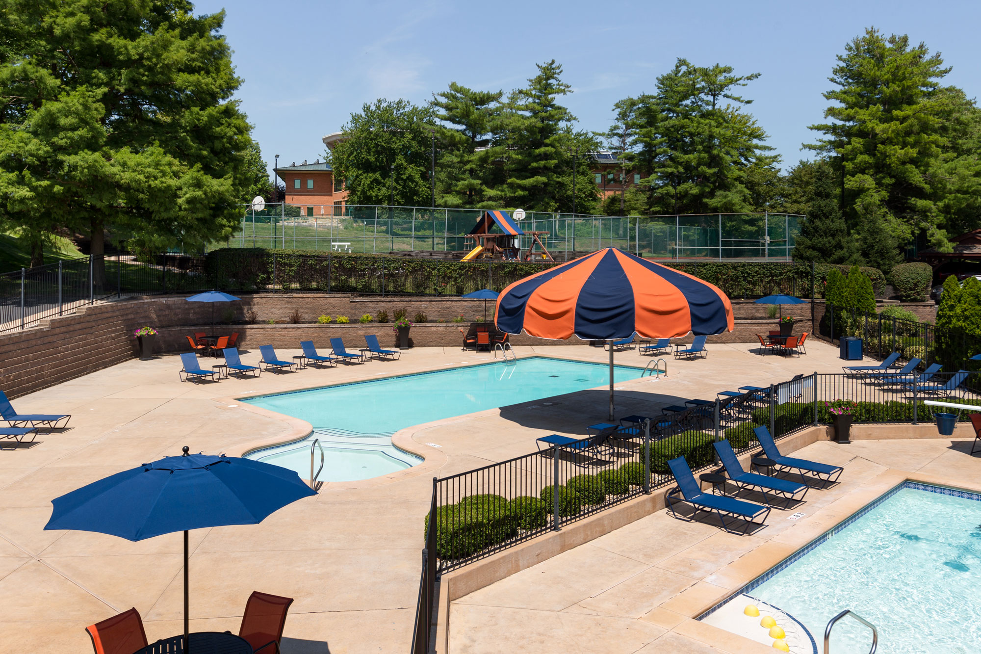 The Chesterfield Village Apartments clubhouse with a view of both pools