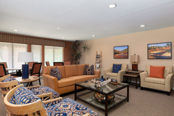 the fireplace hangout with chairs and a sofa at Chesterfield Village Apartments