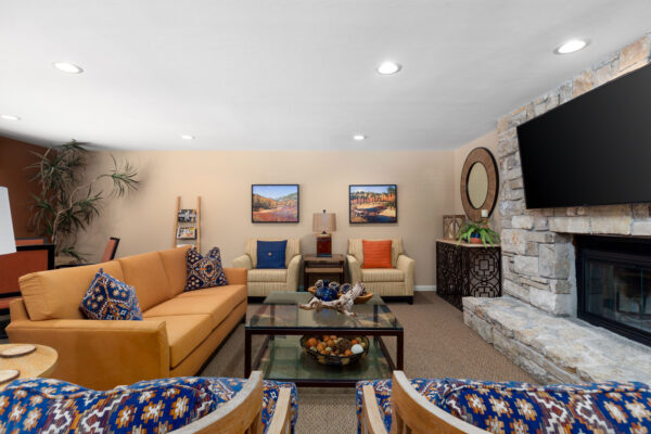 the fireplace hangout with chairs and a sofa at Chesterfield Village Apartments