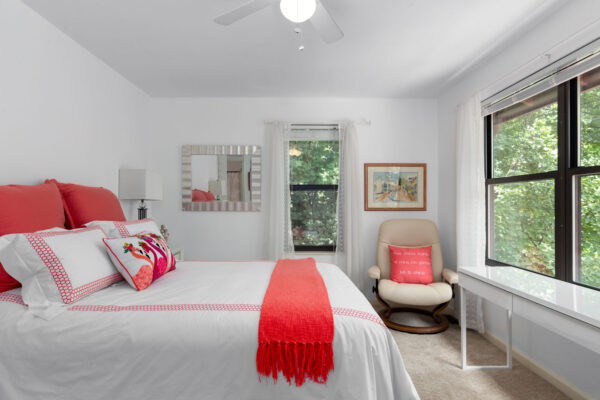 A bedroom with a bed and chair at Chesterfield Village Apartments