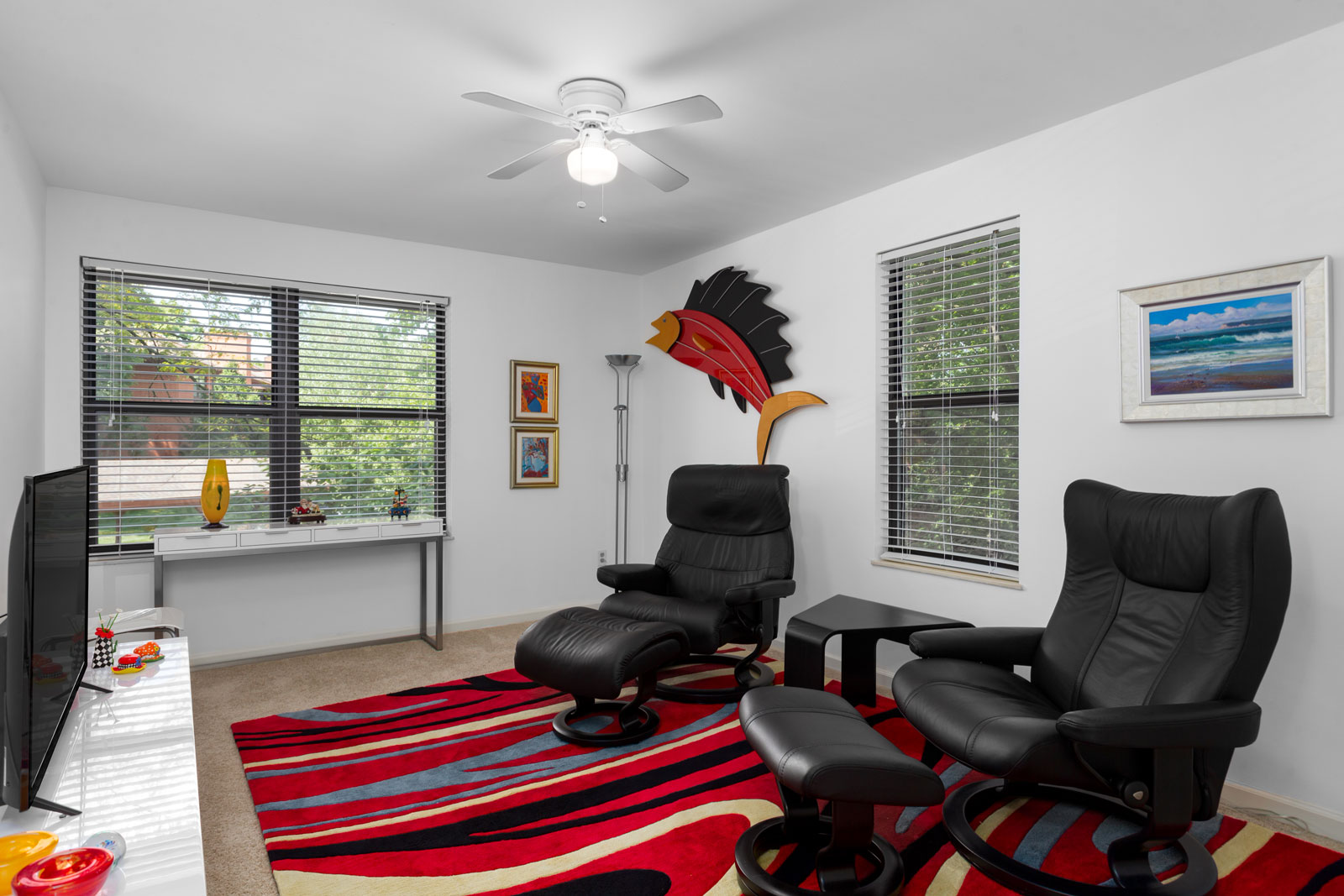 an alternate angle of a room with chairs and a television at Chesterfield Village Apartments