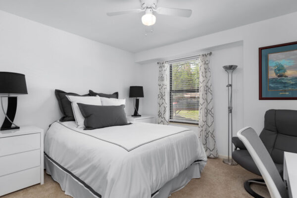 A bed and night stands Chesterfield Village Apartments